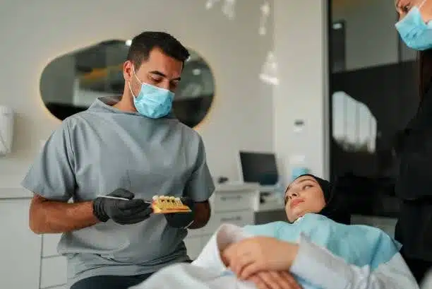 dental-implant-treatment-near-Bedford-Stuyvesant-consultation Dentist reviewing implant treatment plan with patient