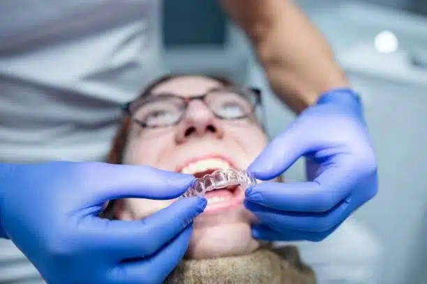 invisalign-Bedford-Stuyvesant -ny-consultation Orthodontist putting dental aligners during Invisalign consultation