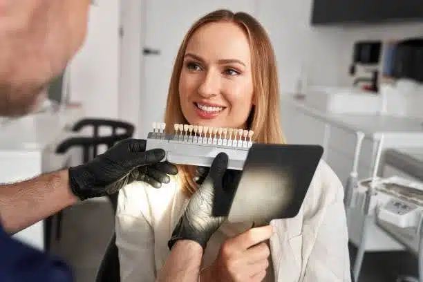 veneers-Bedford-Stuyvesant-ny-consultation Dentist showing dental veneer shade options during a cosmetic consultation