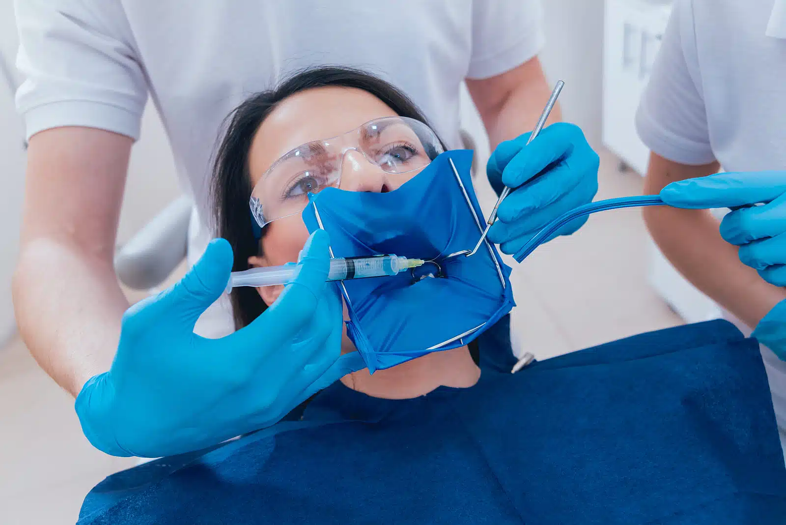 Dentist performing root canal procedure with patient comfortable in chair