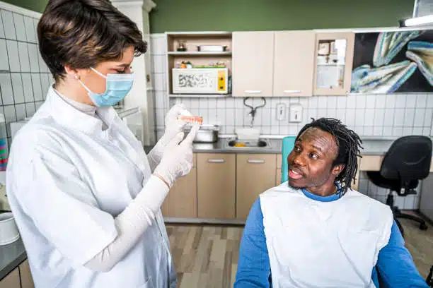 clinton-hill-dental-treatment-consultation Dentist explaining treatment options to a patient