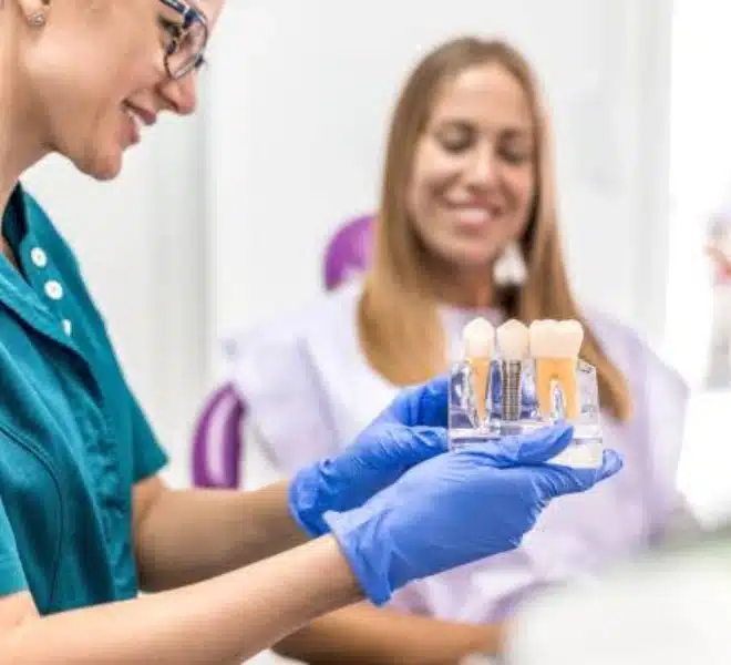dental-implants-williamsburg-ny-consultation Dentist explaining dental implant treatment to a patient